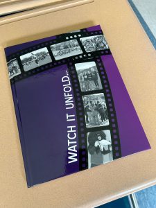 A copy of the 2024 Torch, titled Watch it Unfold...with photos on cover in filmstrip style.