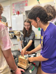 Students work on Rube Goldberg machine.