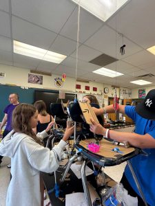 Students work on Rube Goldberg machine.