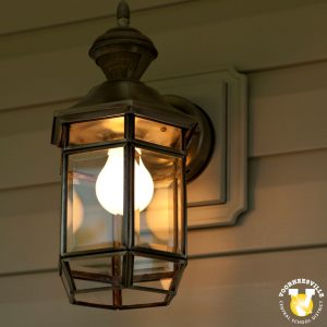 Illuminated porch light. Voorhessville Central School District, V, and blackbird logo.